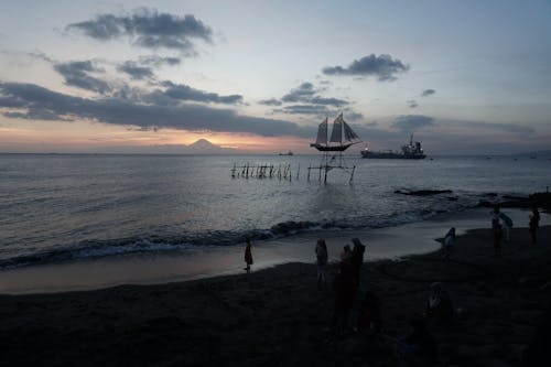 Big toy boat on sea poles near tropical beach