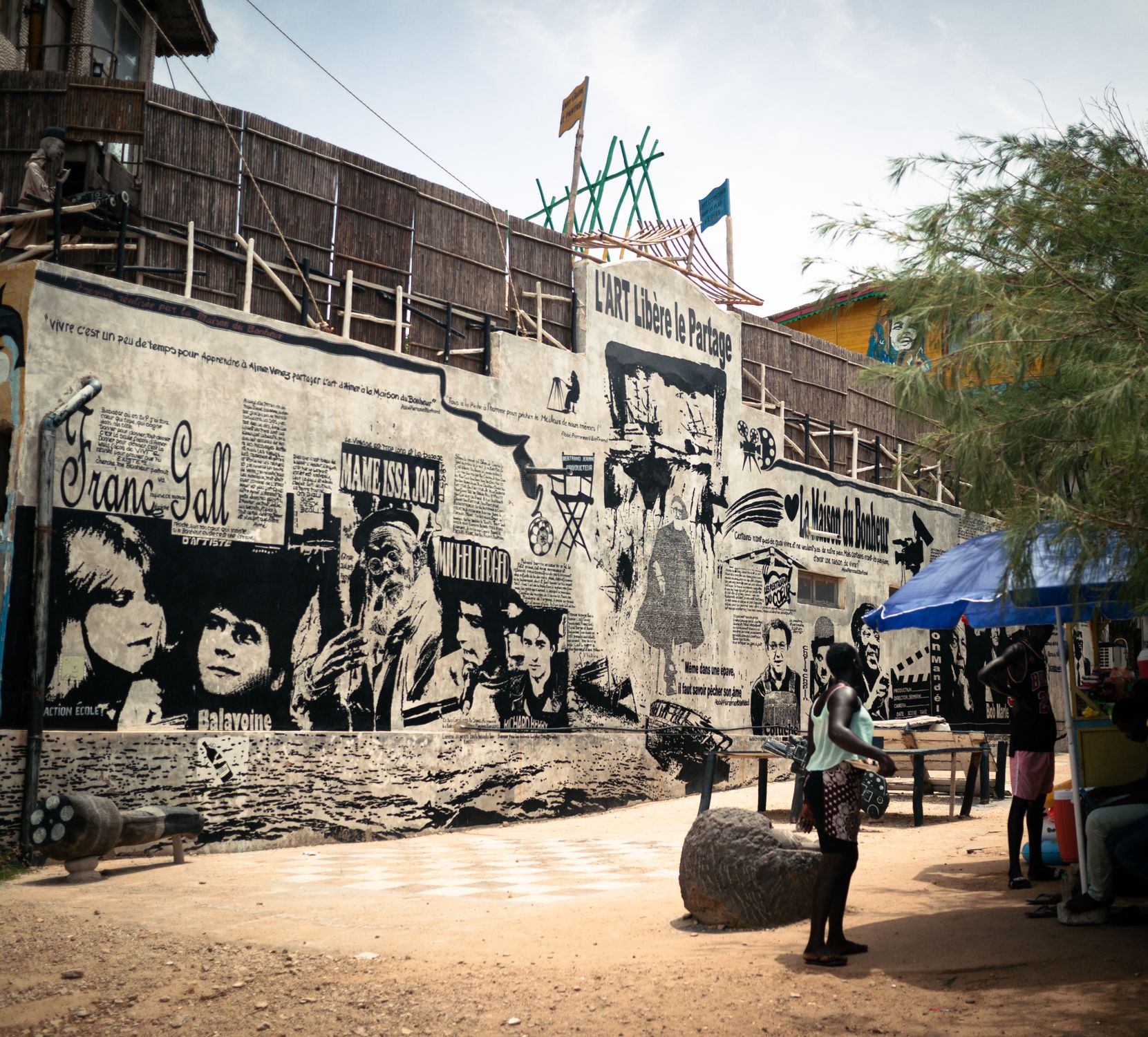 Vibrant street mural on a wall in a town in Senegal depicting urban life Vibrant street mural on a wall in a town in Senegal depicting urban life