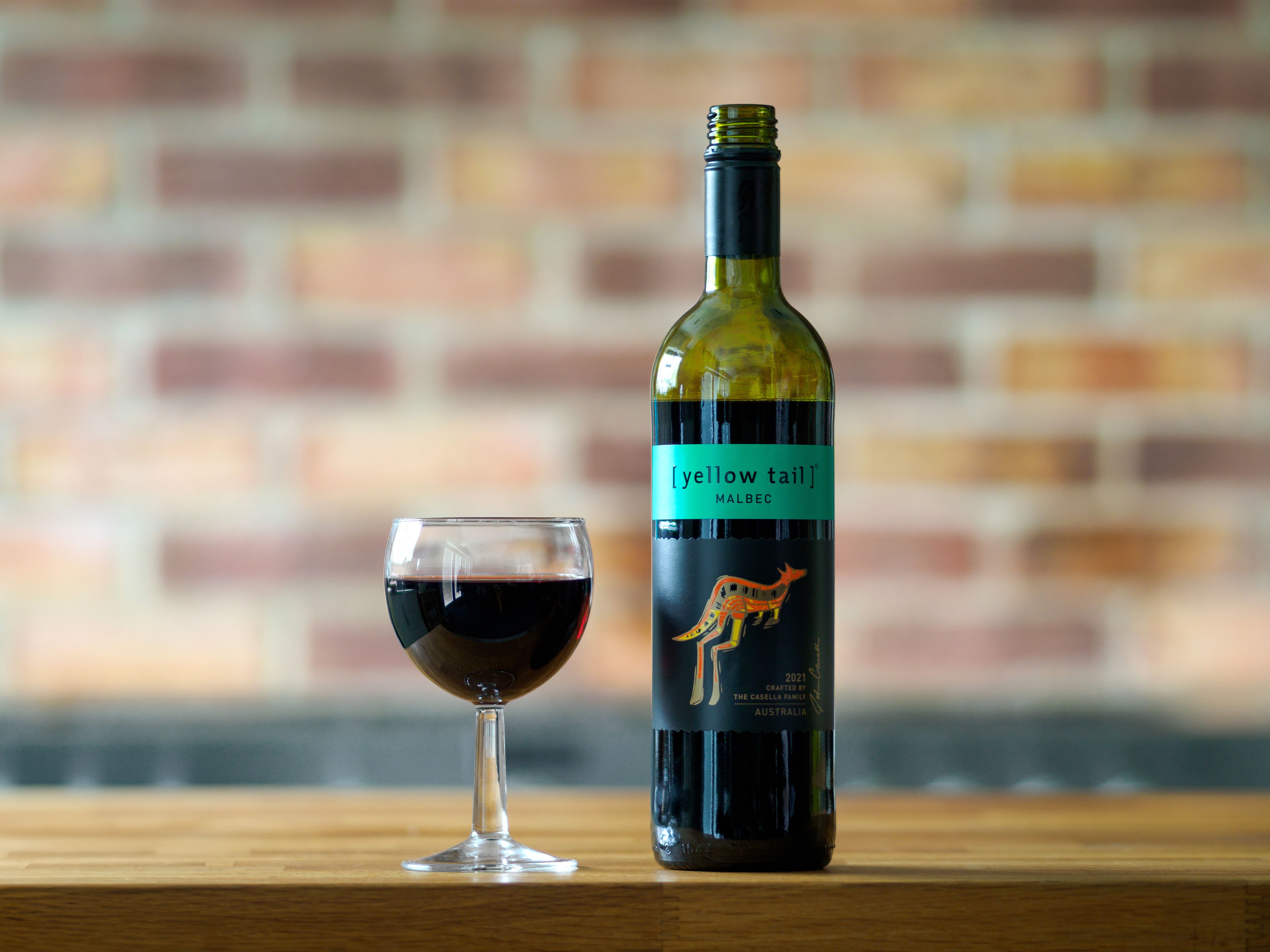 A glass of deep ruby Malbec wine showcasing its characteristic color and clarity.