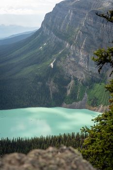 Breathtaking view of turquoise lake and rugged mountains in Banff National Park, Canada.