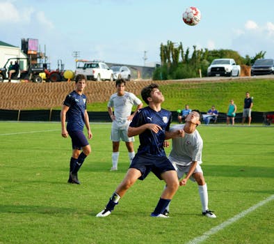 Action-packed soccer match on a sunny day in Knoxville with young players in focus.