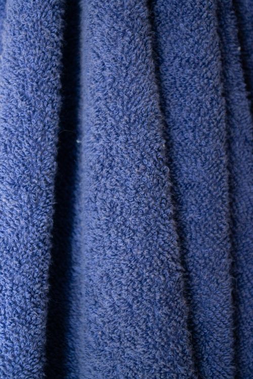 Free Close-up of navy blue terrycloth fabric showcasing its textured surface and plush material. Stock Photo