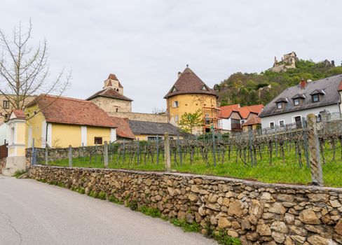 Scenic spring view of a quaint Dürnstein village street lined with historic buildings.