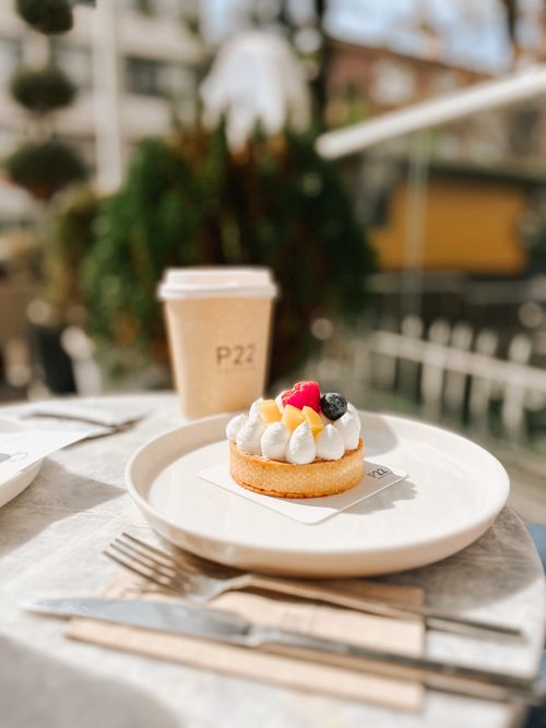 Free Savor a fruit tart and coffee at a cozy Ankara cafe. Perfect for urban vibes and sweet treats. Stock Photo