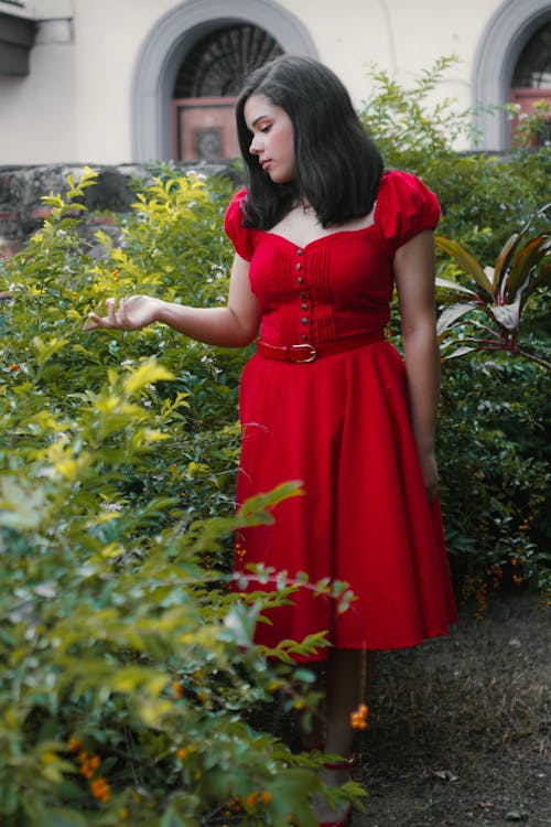 Young Woman Wearing Red A-Line Midi Dress in the Garden