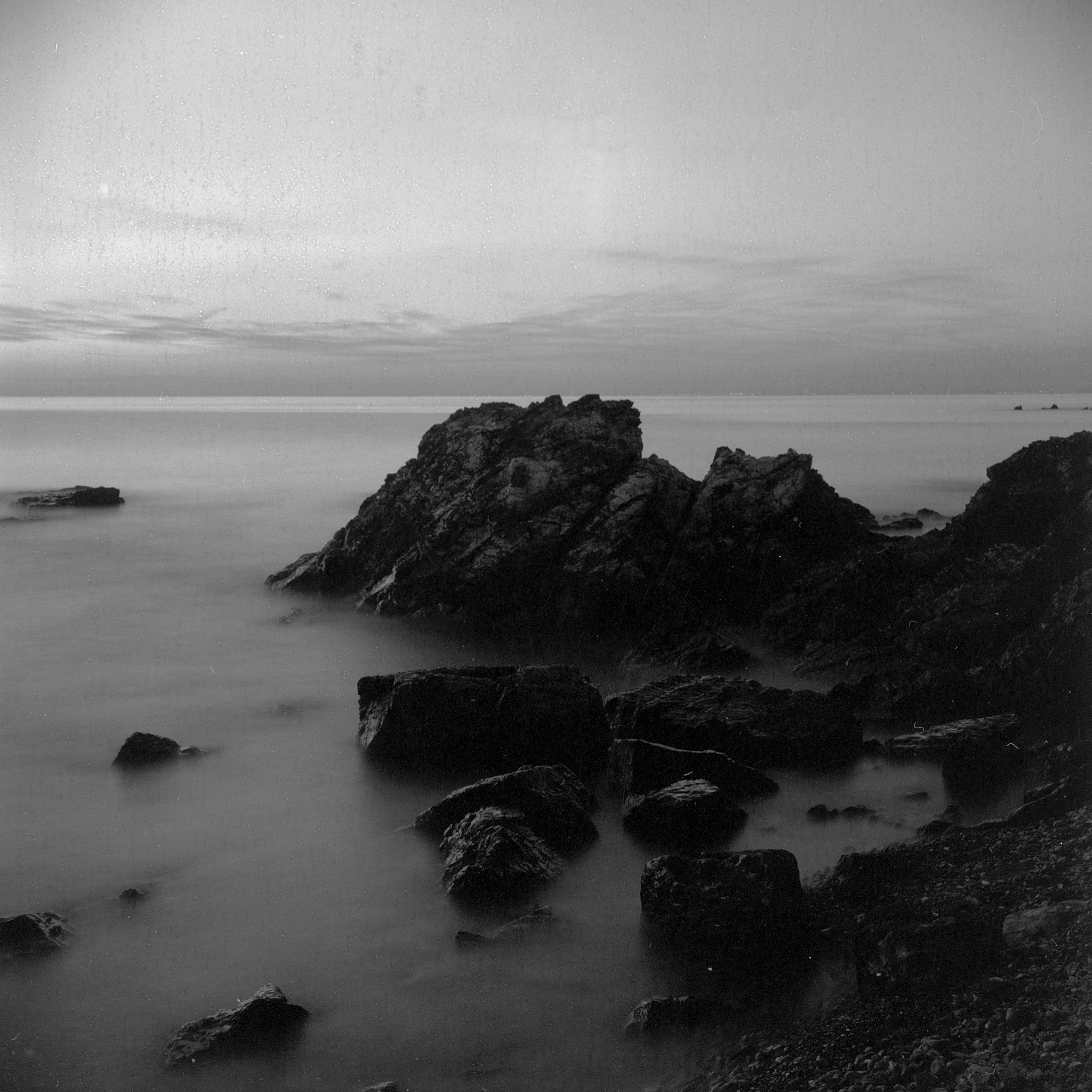 Eroded rocks on the serene Adalar coast in black and white, showcasing nature's beauty.