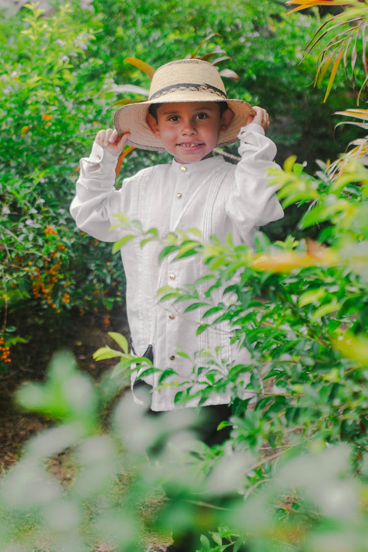 Small Boy Holding The Brim Of His Hat