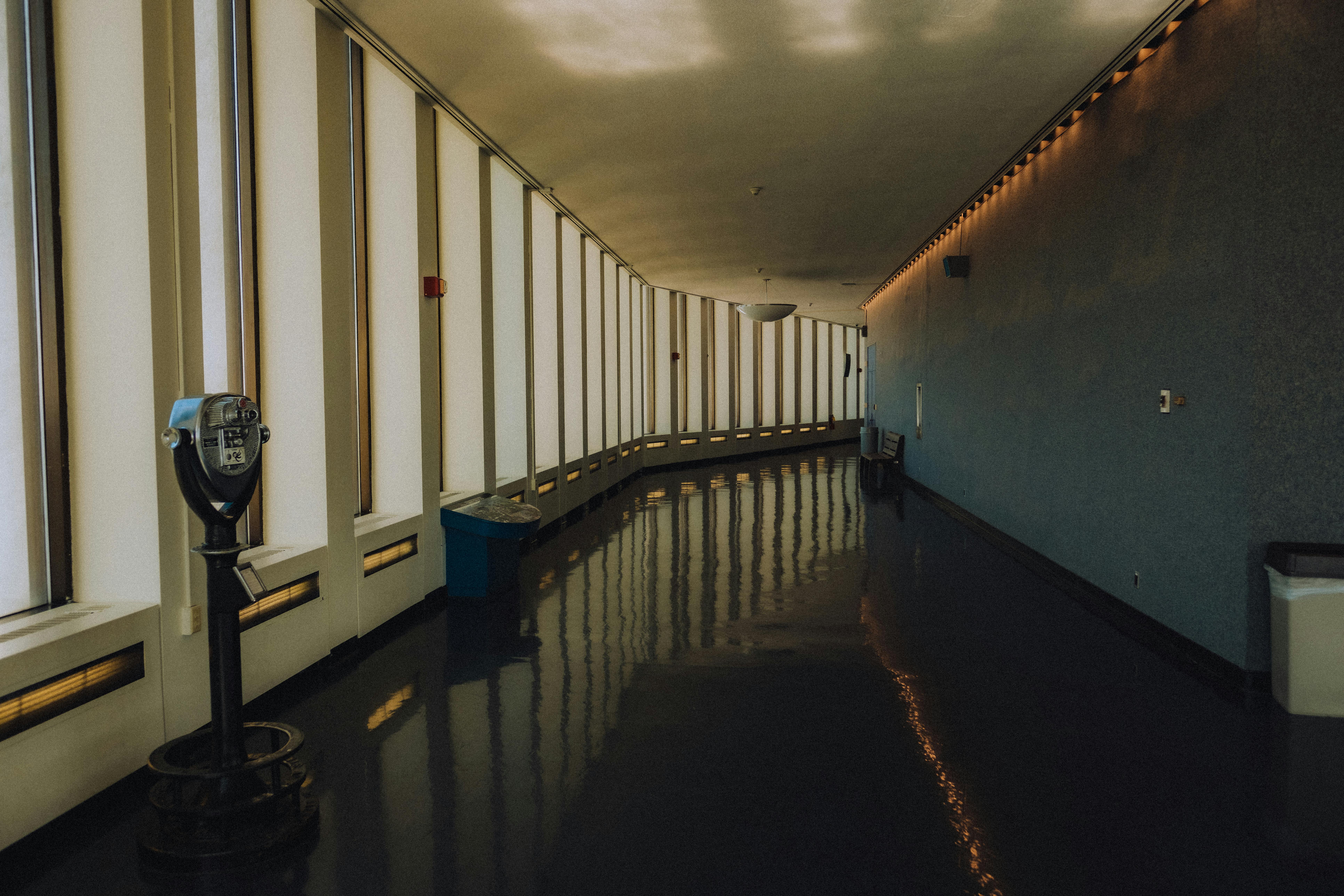 Polished hotel corridor floor reflecting overhead lighting - Castleton hotel facility cleaning