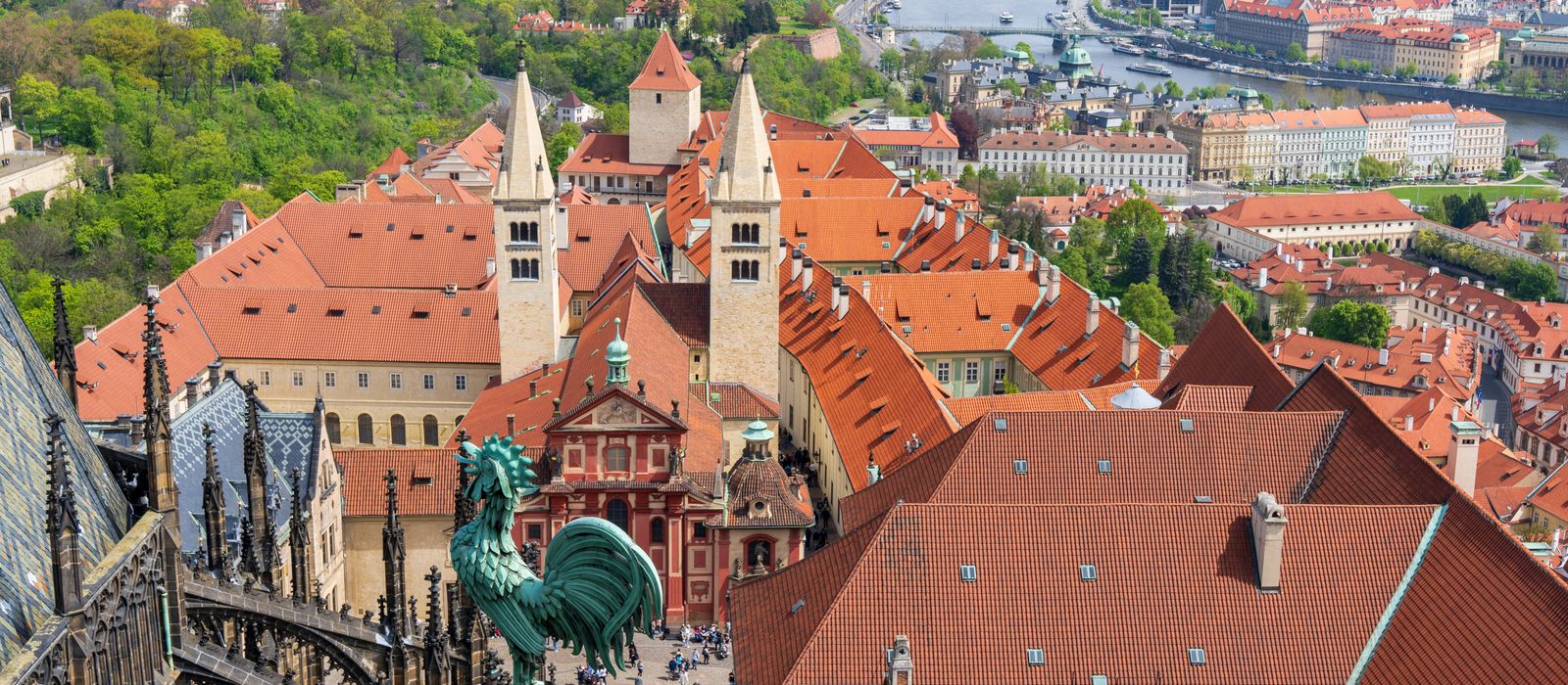 Aerial view of Prague old town with iconic St. George's Basilica and scenic cityscape.