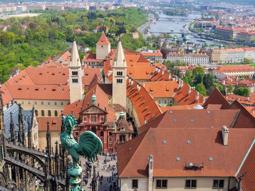 Aerial view of Prague old town with iconic St. George's Basilica and scenic cityscape.