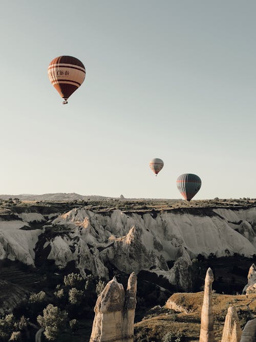 Balloons Floating over Landscape of Cappadocia in Turkey
