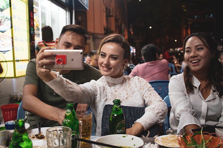 Couple Taking Selfie At Restaurant