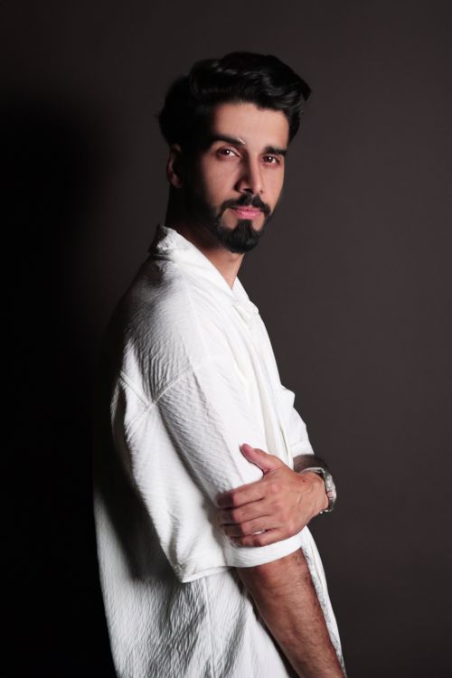 Free Stylish portrait of a young man in a white shirt with dark background. Stock Photo