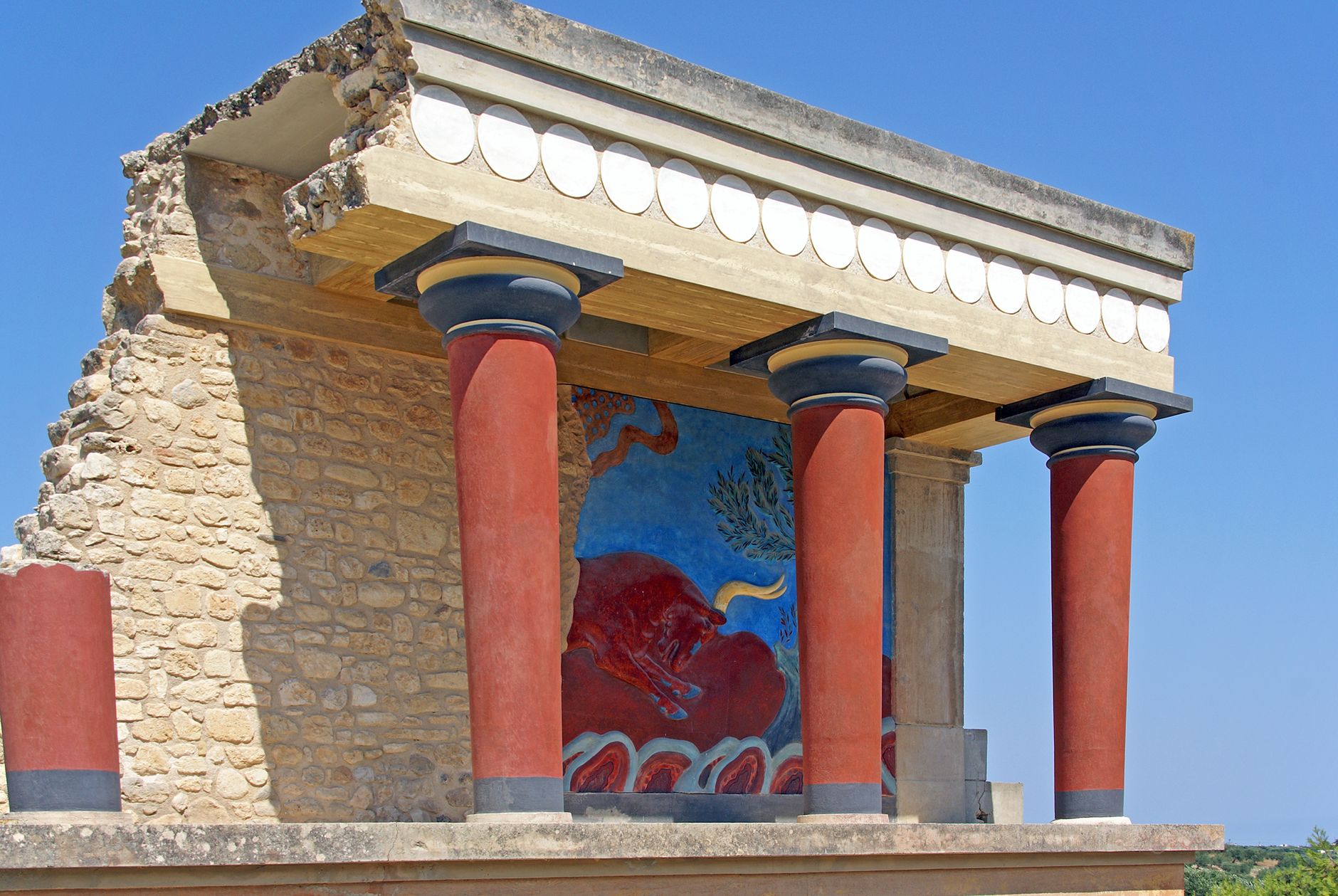 Ancient Knossos Palace ruins with red columns in Crete