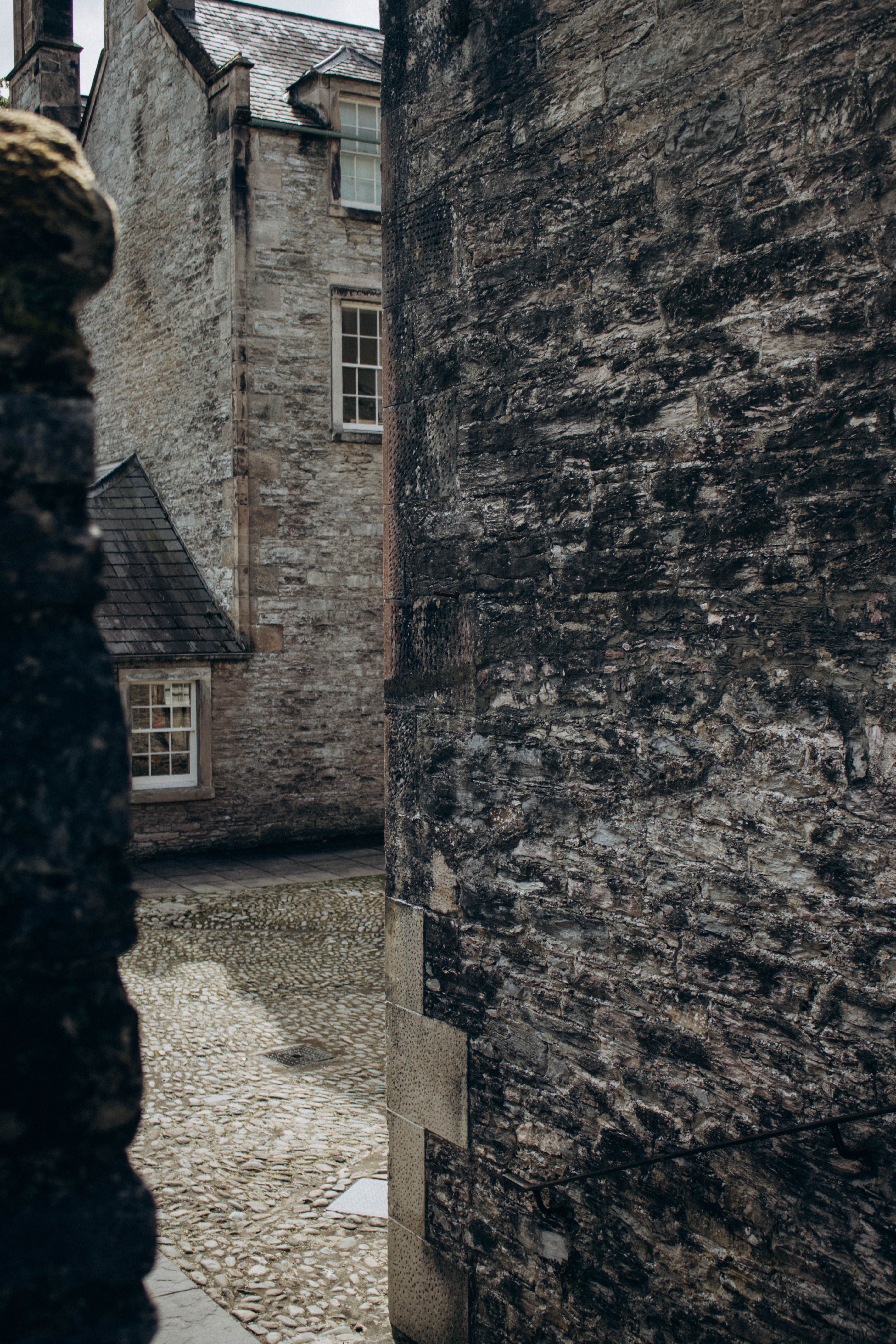 Stone Building and Cobblestone Pavement · Free Stock Photo