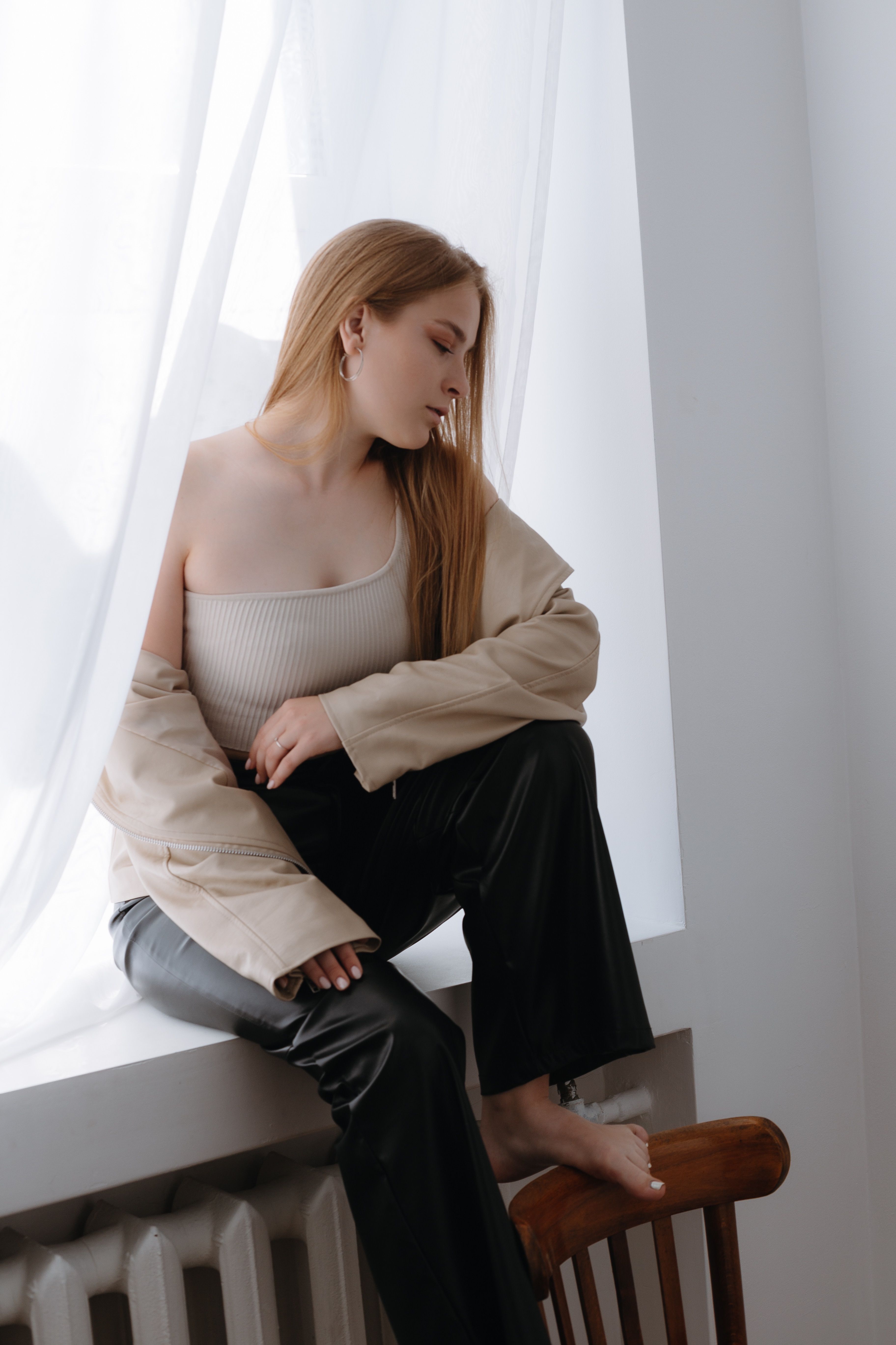 Stressed Woman Sitting on Window Sill · Free Stock Photo - Window And Sill Perching For Stress Relief