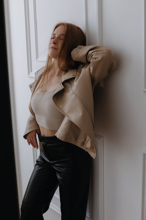 Young Woman Posing in Beige Leather Jacket and Black Pants