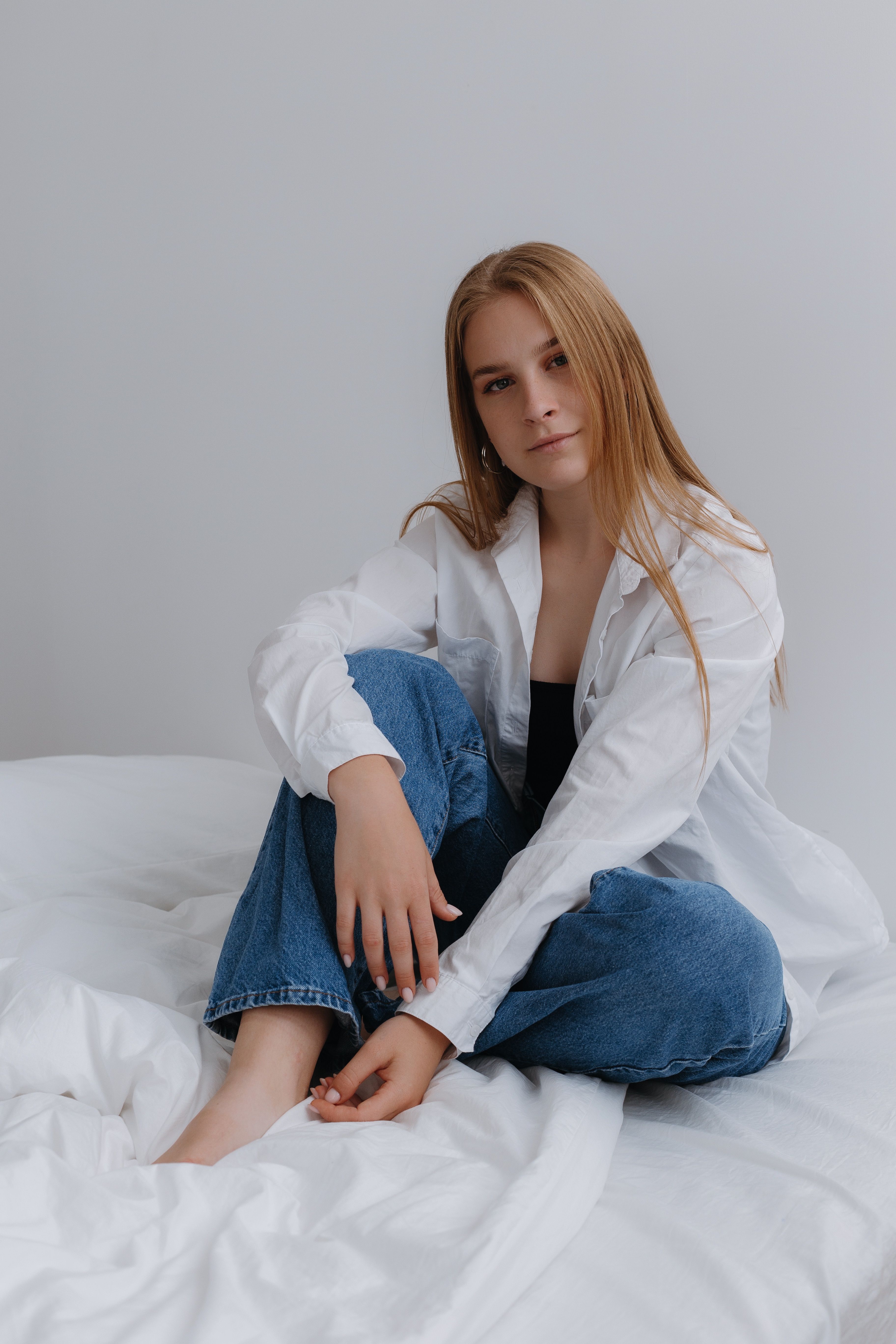 Woman in Shirt Posing on Bed · Free Stock Photo