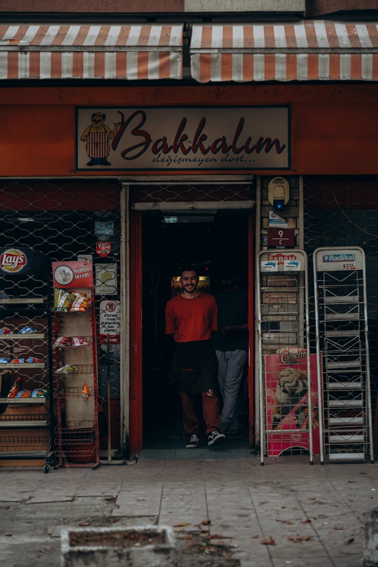 Smiling Man In Store Entrance