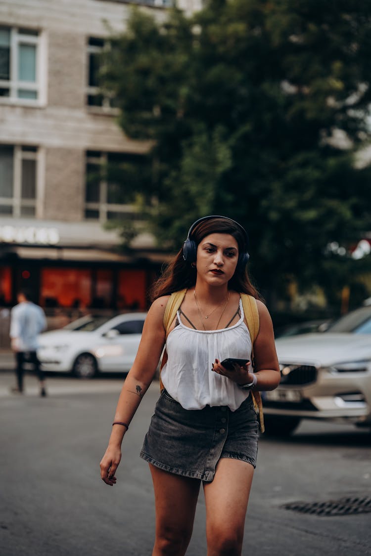 Woman Walking In Headphones And With Smartphone