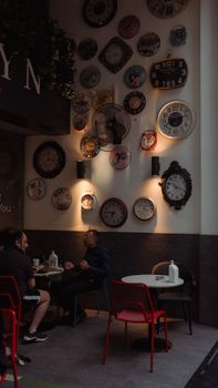 A stylish Istanbul café decorated with vintage wall clocks and modern seating.