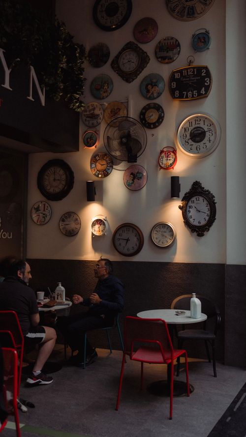 Free A stylish Istanbul café decorated with vintage wall clocks and modern seating. Stock Photo