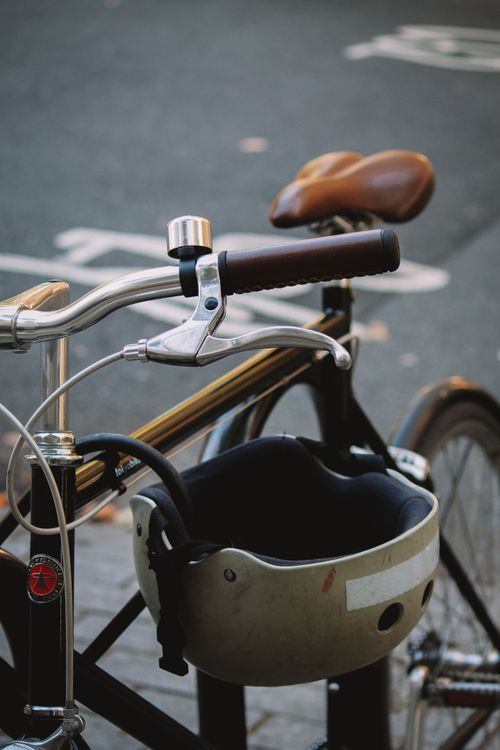 Free Detailed view of bicycle handlebars and helmet on a London street captured in daylight. Stock Photo