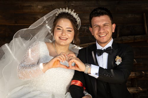 Bride and Groom Making a Heart Shape with Their Hands 