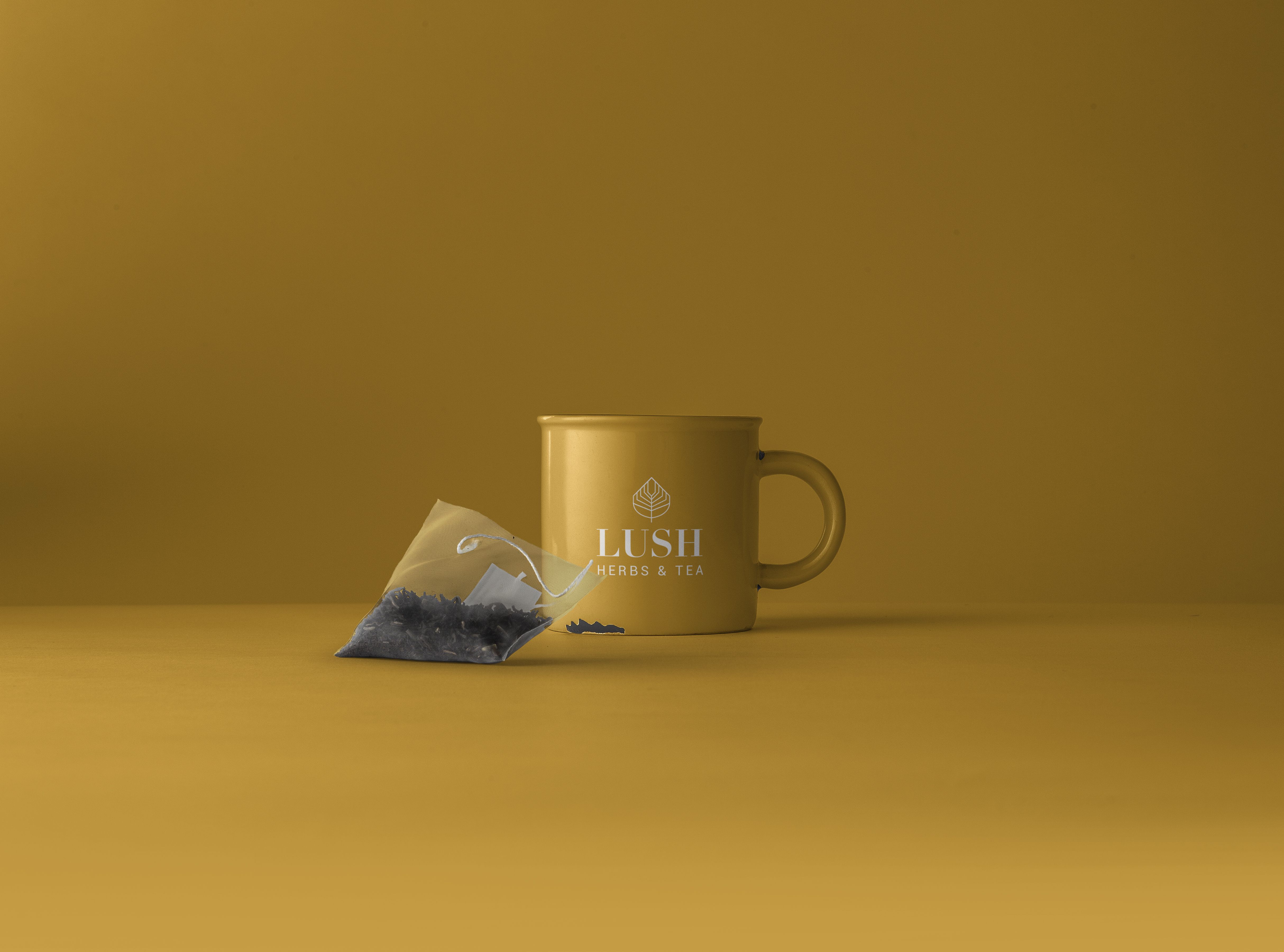 Minimalistic yellow mug with a tea bag, ideal for cafe promotions or branding concepts.