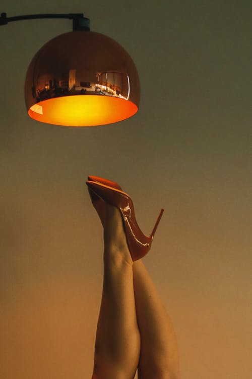 Lamp over Woman Legs in High Heels