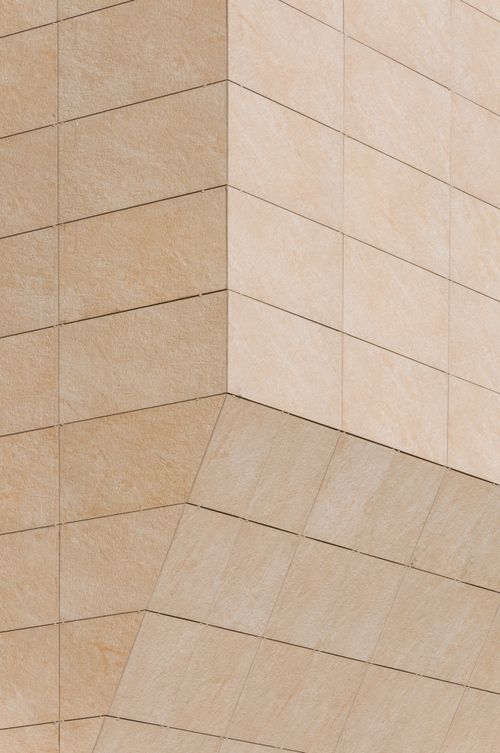 Free Minimalist stone facade showcasing geometric patterns in modern architecture style. Stock Photo