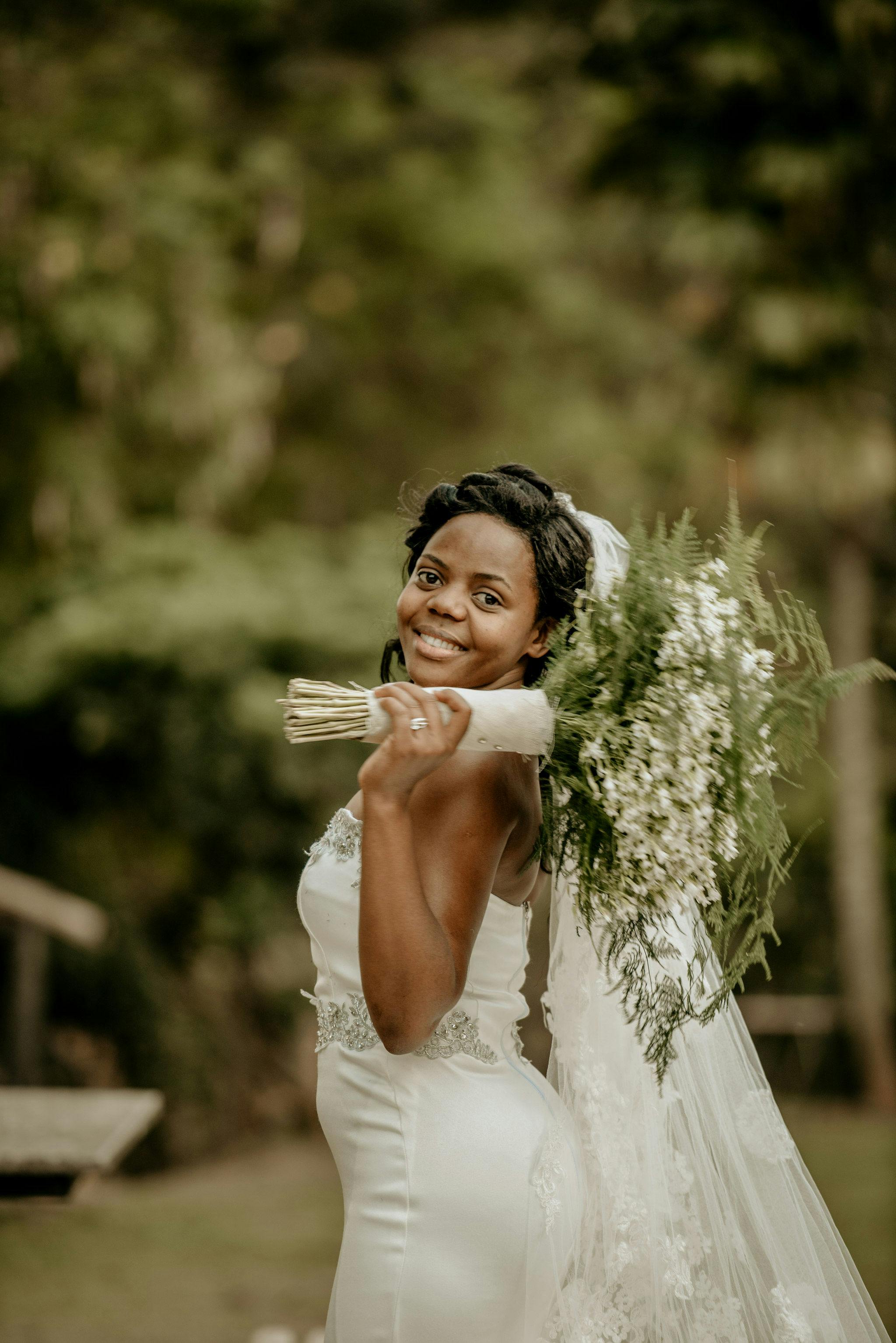 smiling bride with flowers bouquet