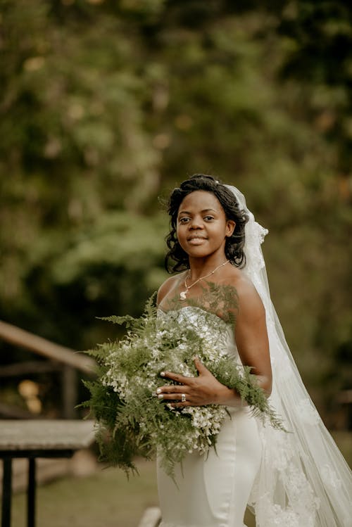 Bride Standing and Holding Plants
