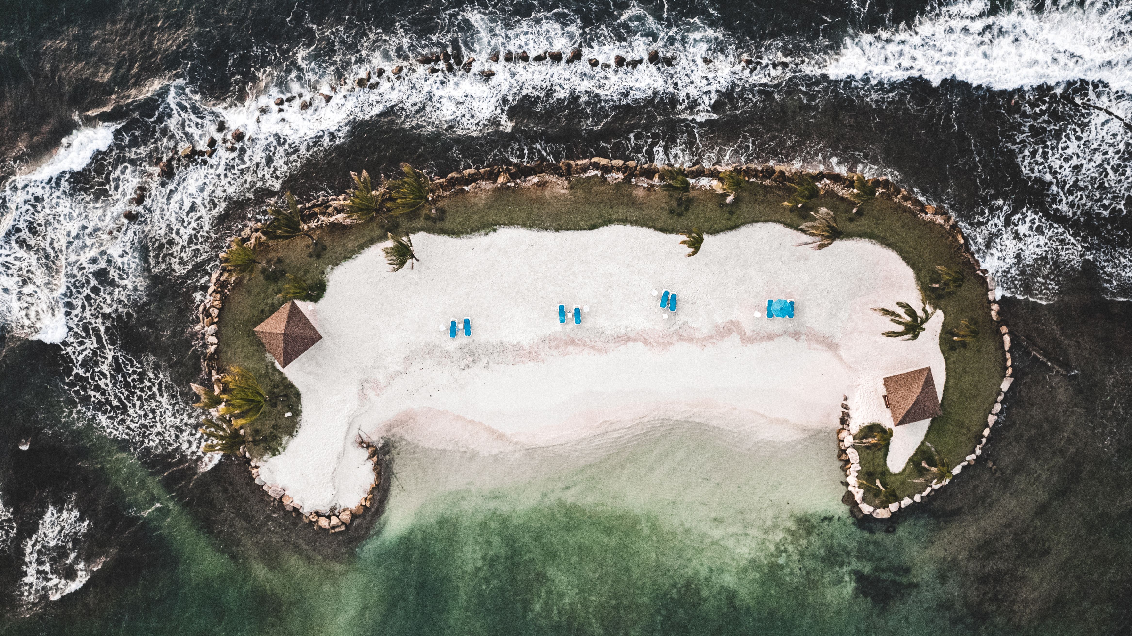 Sandy Islets with Thatched Gazebo and Sunshades · Free Stock Photo