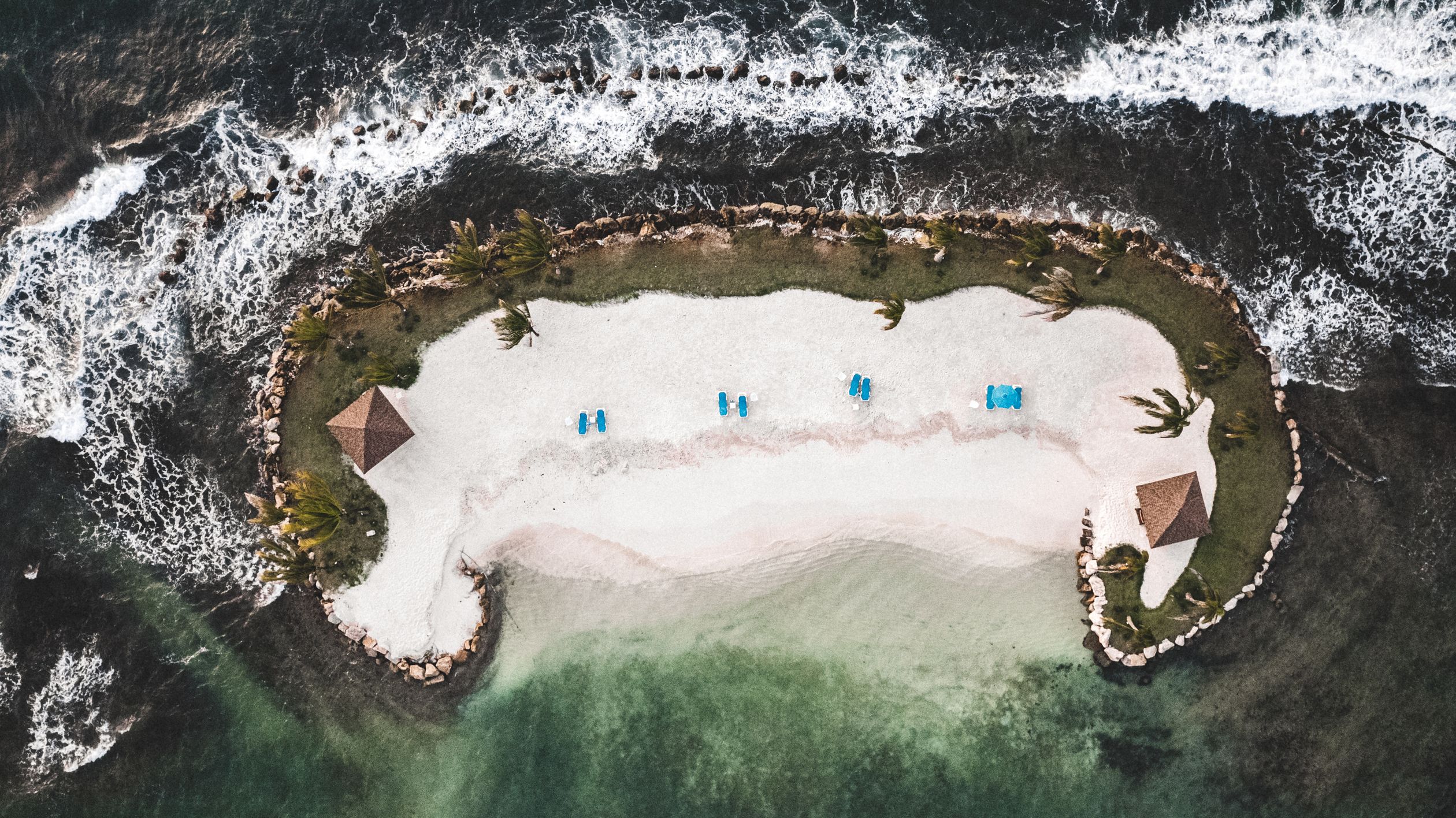 Sandy Islets Sandy Islets with Thatched Gazebo and Sunshades · Free Stock Photo