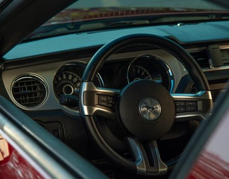 Close-up of Ford Mustang's interior showcasing the steering wheel and dashboard details.