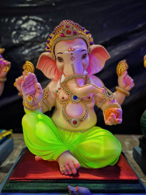 Free A vibrant statue of Lord Ganesha adorned with jewels and intricate designs, symbolizing Hindu spirituality. Stock Photo
