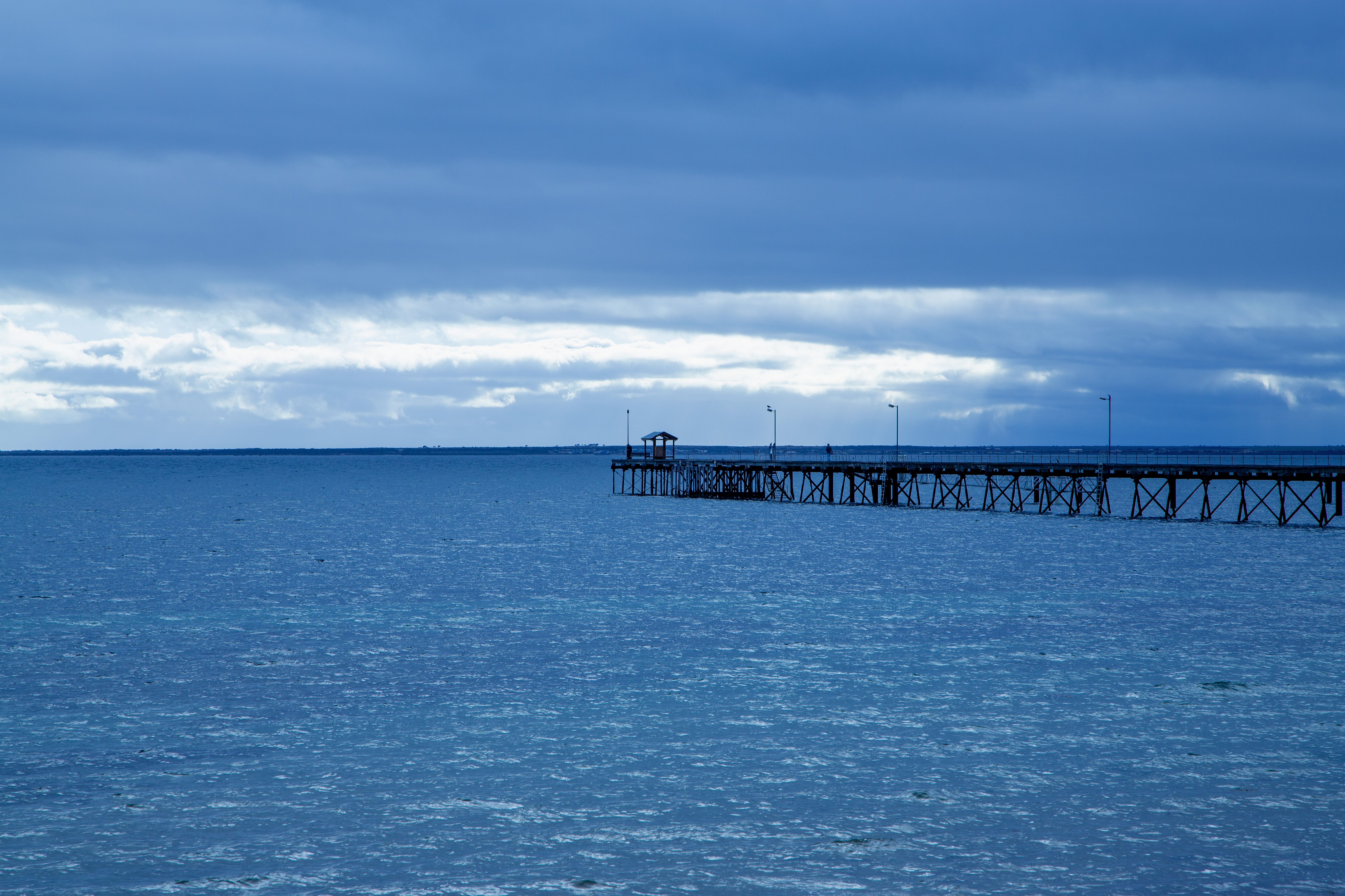 Serene view of the Ceduna jetty stretching into the sea under an overcast sky.