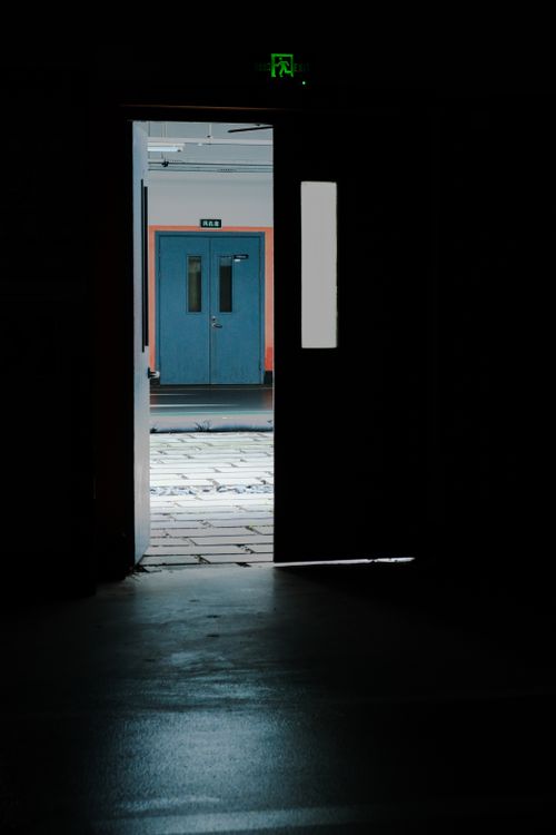 Free Interior view of an open door leading to a bright blue outdoor environment. Stock Photo