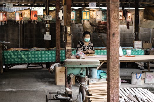 Elderly Asian woman with face mask in a market setting during pandemic.