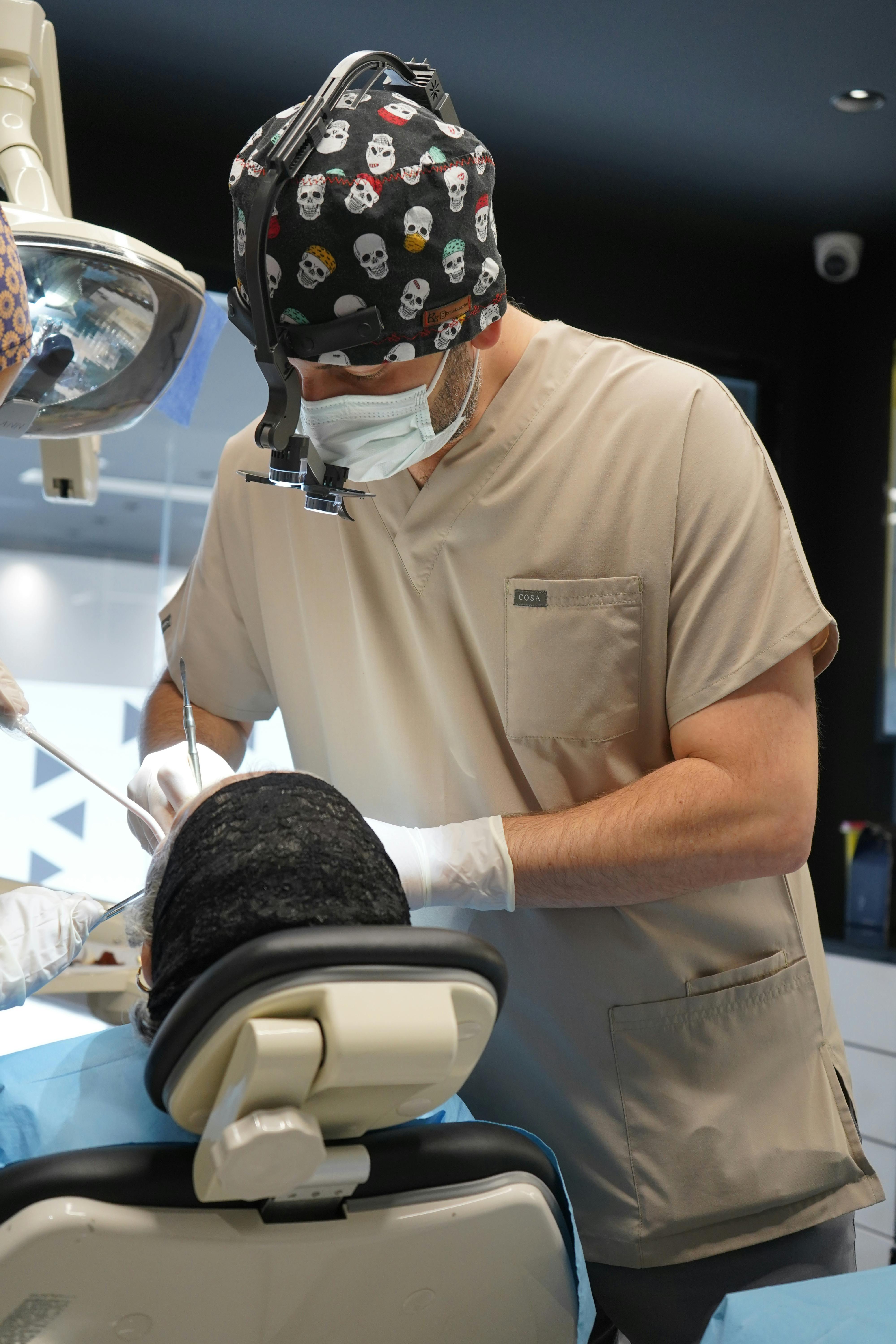 a man in a dental chair with a dentist