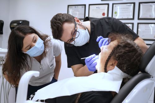 Free Dental professionals performing a procedure in a modern Istanbul clinic, showcasing teamwork and healthcare. Stock Photo