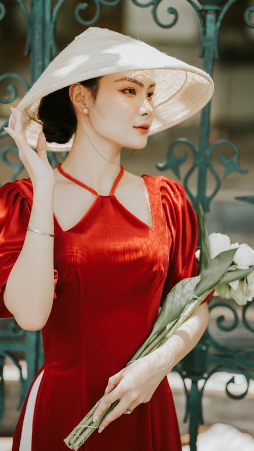 Model in a Red Ao Dai Dress and Non La Conical Hat