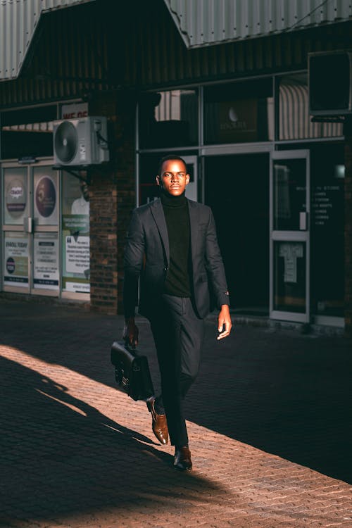 Man Walking in Black Suit