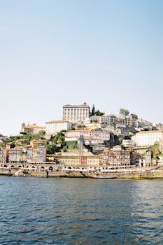 Explore Porto's charming hillside architecture by the sea, showcasing vibrant urban landscapes and cultural heritage.