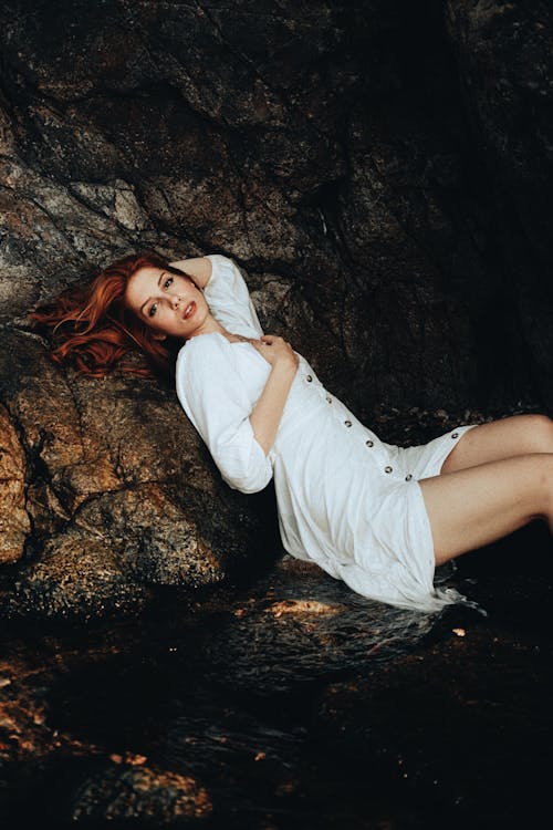 Redhead Woman Posing by Rock