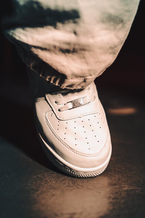 Foot of a Person Wearing a White Shoe