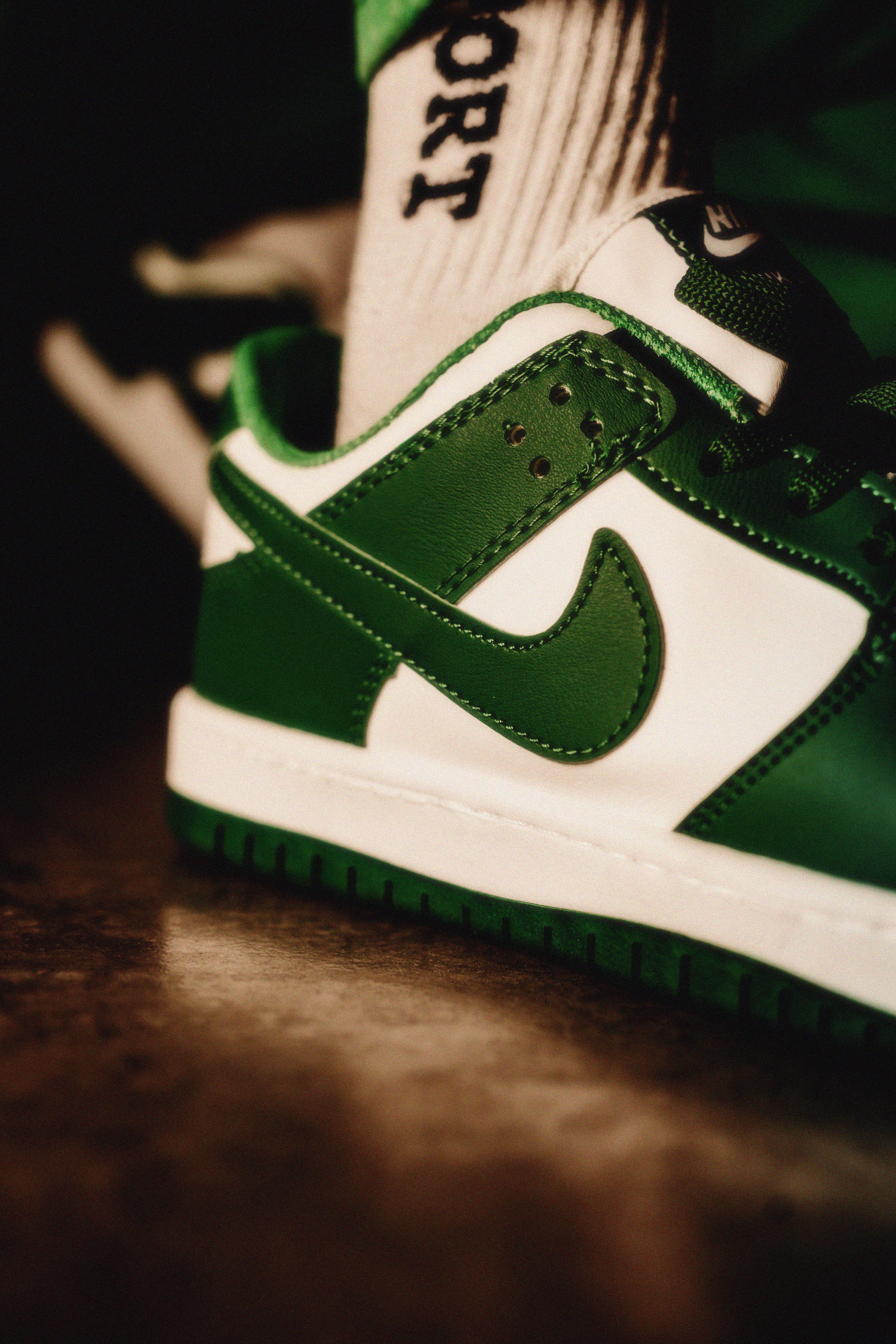 Detailed view of trendy green and white sneakers with sport sock.