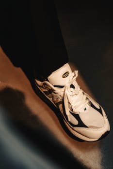 Close-up of white and black running shoe in modern lighting.
