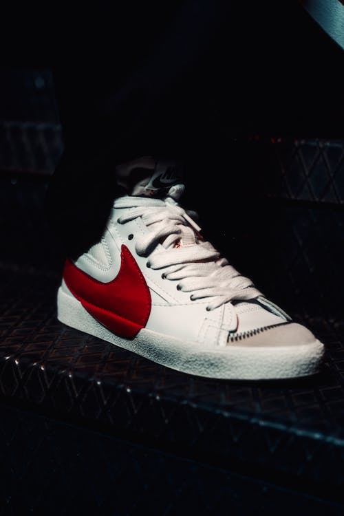 White Sports Shoe with a Red Nike Logo